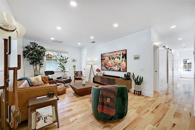 Living area with light wood-style flooring and re