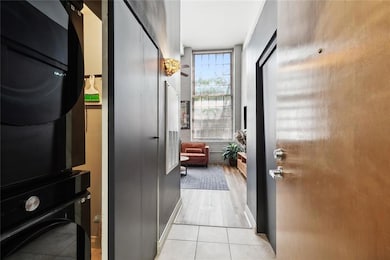 Welcome home to Unit 157 - stepping in the front door, notice the full-size washer dryer tucked in the closet in the entry.