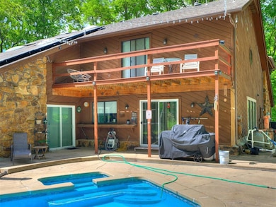 Back of property featuring a patio, a balcony, an 