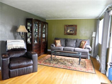 The living room is spacious with ample natural lig