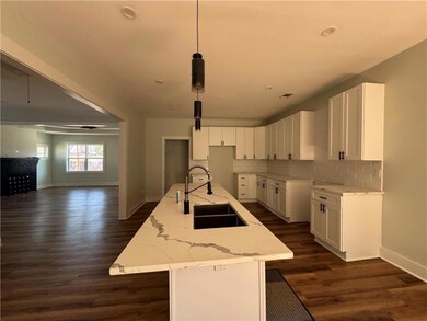 Kitchen featuring tasteful backsplash, light stone