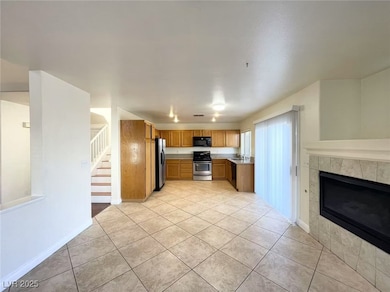 Kitchen featuring light countertops, light tile pa