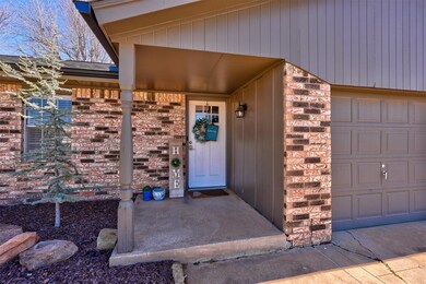 Property entrance featuring brick siding and a gar