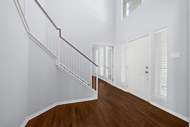 Foyer entrance featuring dark wood-style floors, 