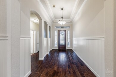 Your entry with beautiful wood floors, tray ceilin