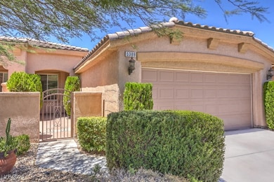Mediterranean / spanish house featuring a gate, stucco siding, a tiled roof, concrete driveway, and a garage
