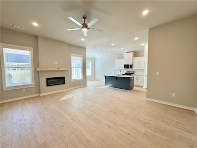 This open living room is a warm and inviting space that combines modern design with cozy comfort.

