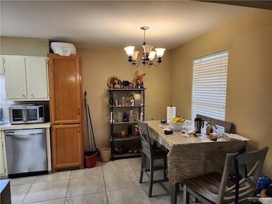 Dining room featuring a chandelier and light tile patterned floors