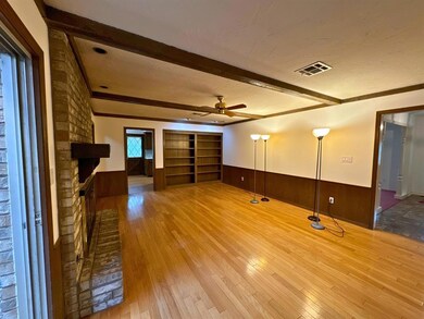 Unfurnished living room with wooden walls, wood-ty