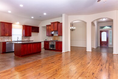 The entryway seamlessly connects to a spacious din