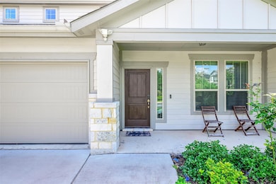 Entrance to property featuring a porch, a garage,