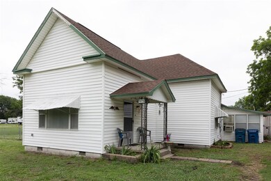 Back of house with a yard