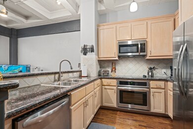 Kitchen features granite countertops, tile backspl