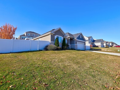 View of front facade with driveway, stucco siding, a residential view, and an attached garage