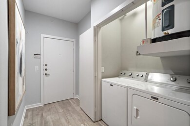 Clothes washing area featuring washing machine and