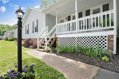 View of side of home featuring covered porch.