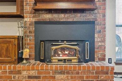 Interior details featuring a wood stove and a bric