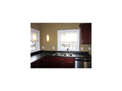Kitchen. Cherry cabinets, tiled floor, stainless a