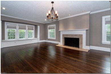 Formal living room has wood burning fireplace , gl
