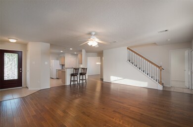 Large family room with updated beautiful wood flooring.