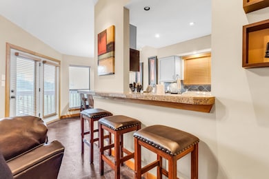 Kitchen with a breakfast bar, recessed lighting, 