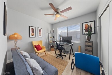 Home office featuring baseboards, wood finished fl