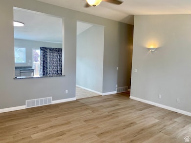 Spare room featuring light wood-style floors and ceiling fan