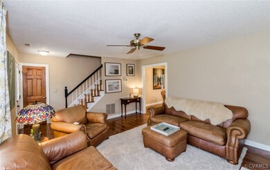Bright open living room with ceiling fan