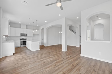 Unfurnished living room with a ceiling fan, visib