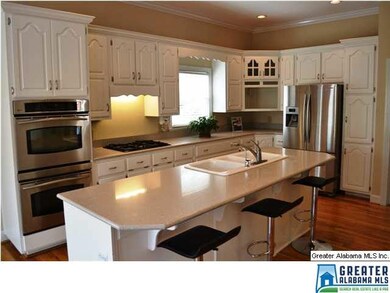 Updated eat-in kitchen with white cabinetry, quart