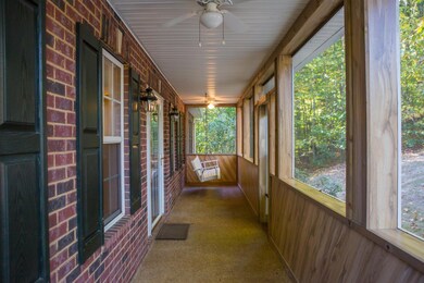 Long screened in front porch has two ceiling fans and plenty of room for your favorite outdoor chairs!