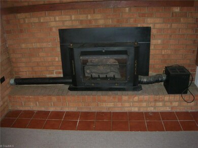 Here you are now in the den with the wood stove heater and blower unit that provides a nice cozy atmosphere on a cold winter evening. You also get the benefit of the extra heating from the wood stove.