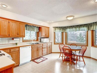 Open and airy eat-in kitchen with windows overlook