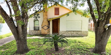 View of front of home with fence, stone siding, and stucco siding