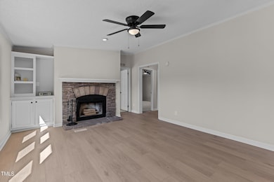 Den with stone fireplace
