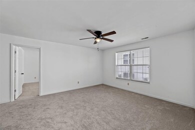 Door in living room leads to master bedroom.