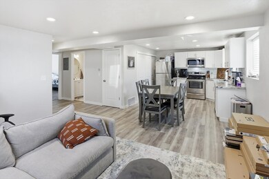 Living area with light wood-type flooring and recessed lighting