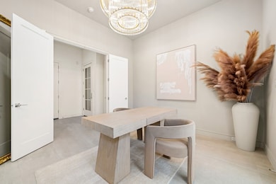 A large, modern chandelier adds sophistication to