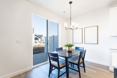 Dining area featuring light wood finished floors and a chandelier
