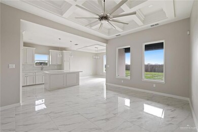 Unfurnished living room featuring light marble finish flooring, coffered ceiling, baseboards, a ceiling fan, and beam ceiling