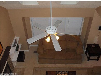 Den/Family/Great Room. View of Den from the upstairs Loft with a fan and fireplace.
