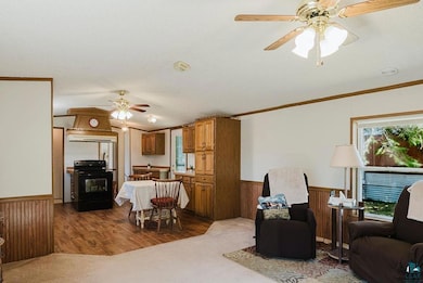 Living area with ceiling fan, ornamental molding, 