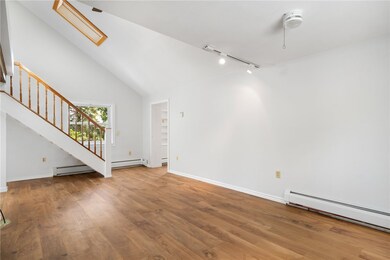 Living/dining room with skylight and windows on Ea