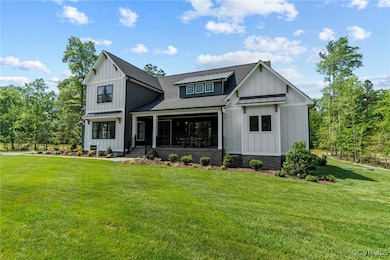 Modern farmhouse style home featuring a front yard
