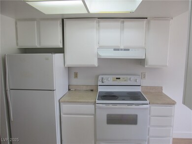Kitchen featuring white appliances, under cabinet