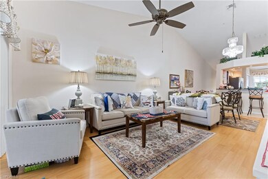 Living room with ceiling fan with notable chandeli