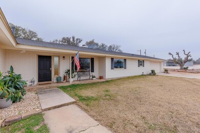 Ranch-style house with brick siding, an attached 