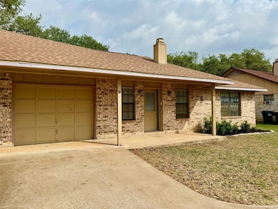Single story home featuring roof with shingles, a