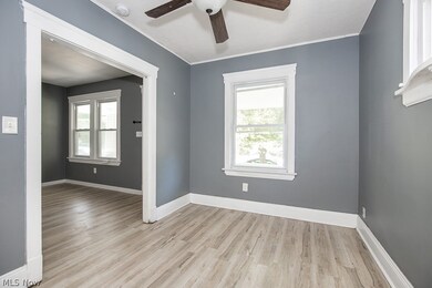 Spare room with light hardwood / wood-style flooring, ornamental molding, and ceiling fan