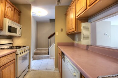 Galley kitchen with linoleum floors and ceiling fa